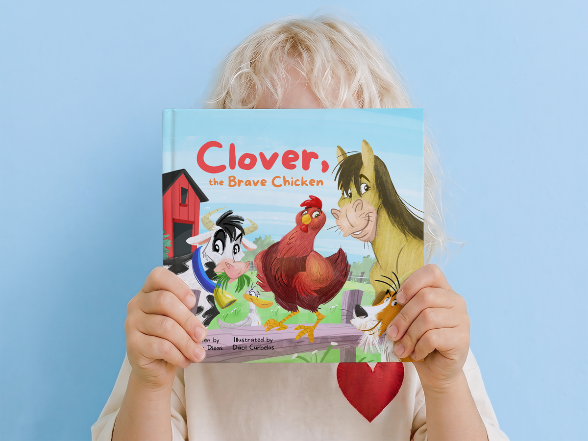 Boy holding the picture book Clover, the Brave Chicken